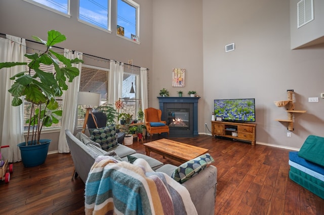605 Hickory Run Dr, Cedar Park, TX 78613 - living room featuring a high ceiling, wood-type flooring, and a fireplace with flush hearth