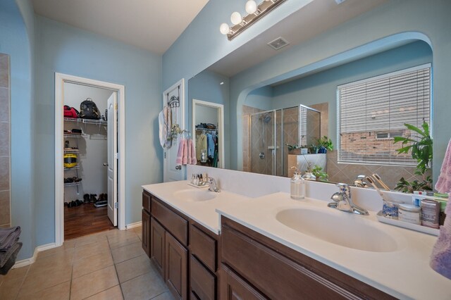605 Hickory Run Dr, Cedar Park, TX 78613 - full bath featuring a shower stall, double vanity, a walk in closet, and tile patterned floors