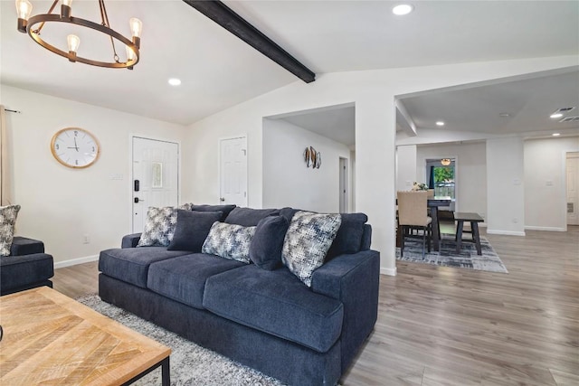 living room featuring recessed lighting, wood finished floors, and a notable chandelier