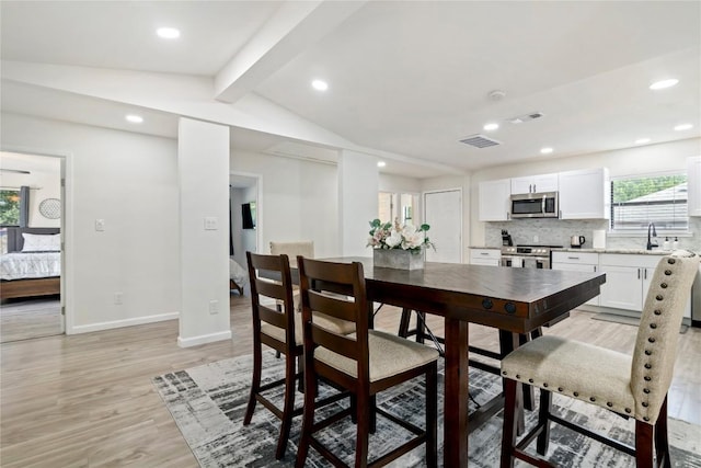 dining area with visible vents, baseboards, lofted ceiling with beams, light wood-style floors, and recessed lighting