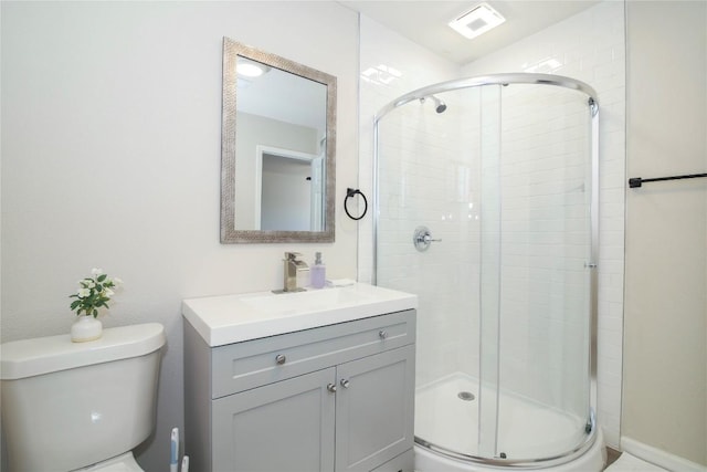 full bathroom featuring vanity, a stall shower, toilet, and visible vents