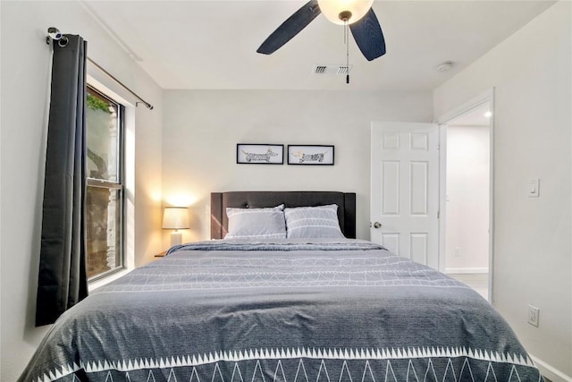 bedroom featuring a ceiling fan, baseboards, and visible vents