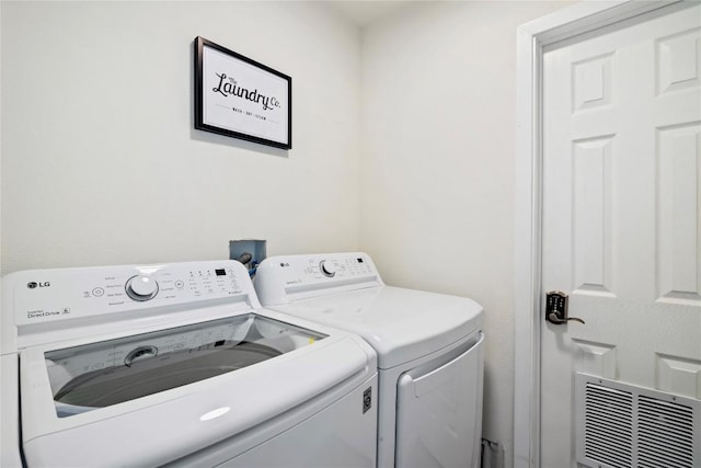 laundry room featuring laundry area, independent washer and dryer, and visible vents