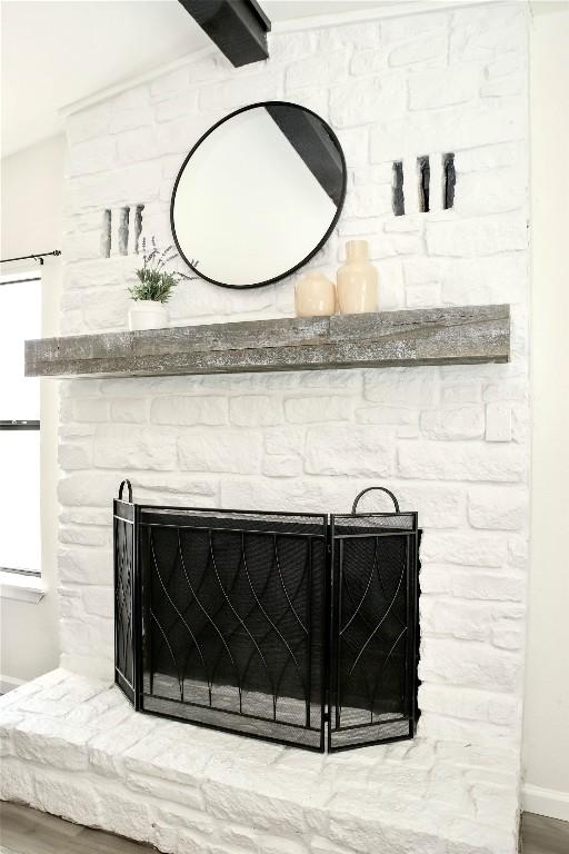 details featuring baseboards and a fireplace