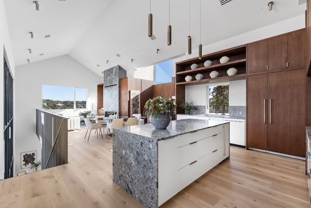 kitchen with open shelves, white cabinetry, a kitchen island, modern cabinets, and plenty of natural light