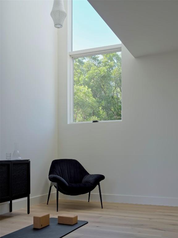 living area featuring wood finished floors and baseboards