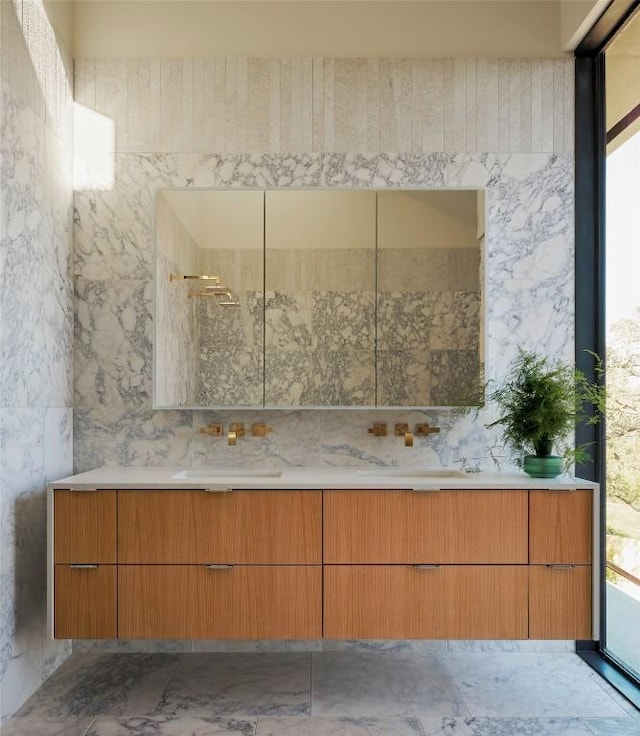 bathroom with a sink and double vanity