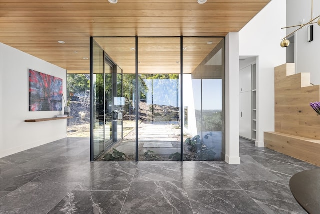 entryway with marble finish floor, wood ceiling, and floor to ceiling windows