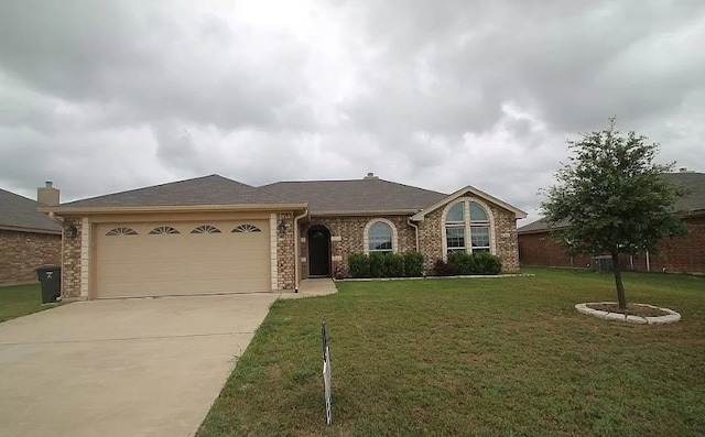 ranch-style home featuring concrete driveway, a front lawn, an attached garage, and brick siding