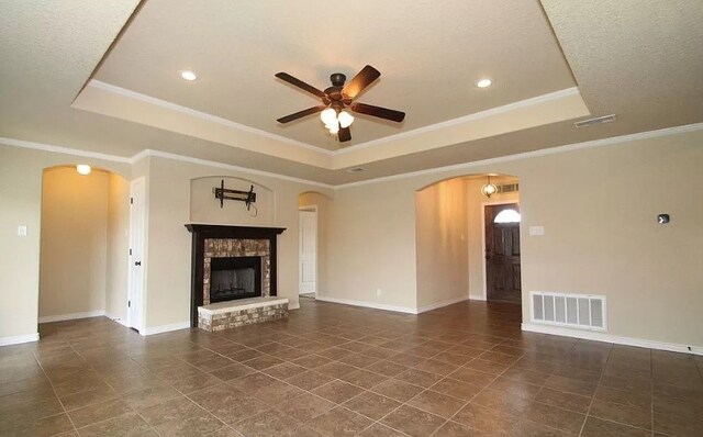 503 W Gemini Ln, Killeen, TX 76542 - unfurnished living room featuring a raised ceiling, arched walkways, ceiling fan, tile patterned floors, and crown molding