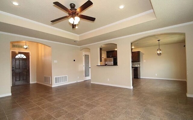 503 W Gemini Ln, Killeen, TX 76542 - unfurnished living room featuring a ceiling fan, a raised ceiling, arched walkways, ornamental molding, and recessed lighting