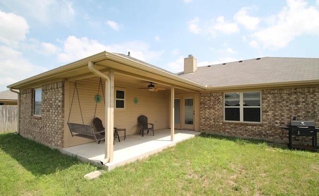 503 W Gemini Ln, Killeen, TX 76542 - back of house with ceiling fan, a chimney, a lawn, a patio area, and brick siding
