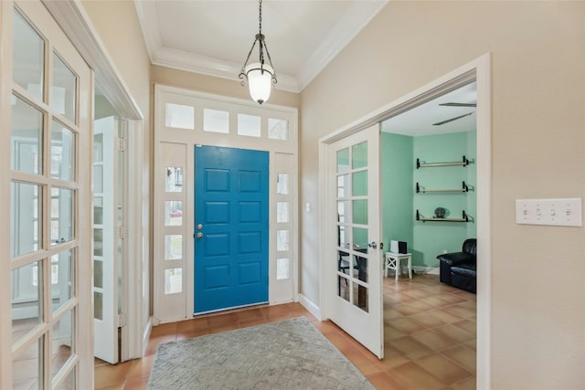 entrance foyer featuring french doors, crown molding, and baseboards