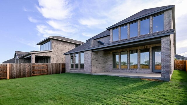 657 Bay Breeze Dr, Kyle, TX 78640 - back of house featuring brick siding, a patio, and a fenced backyard
