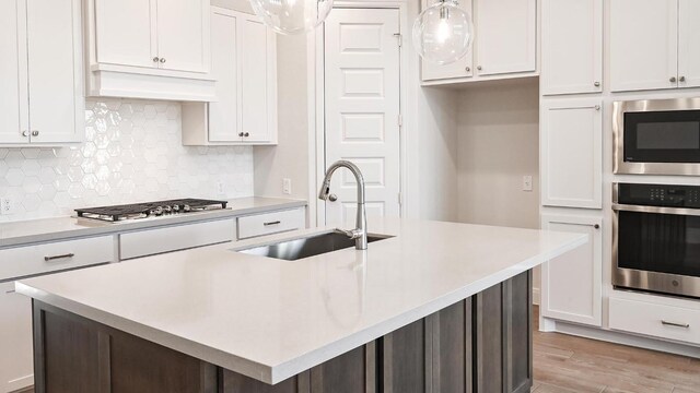 657 Bay Breeze Dr, Kyle, TX 78640 - kitchen with appliances with stainless steel finishes, white cabinets, and light countertops