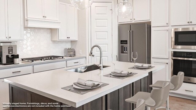 657 Bay Breeze Dr, Kyle, TX 78640 - kitchen featuring stainless steel appliances, white cabinets, and light countertops