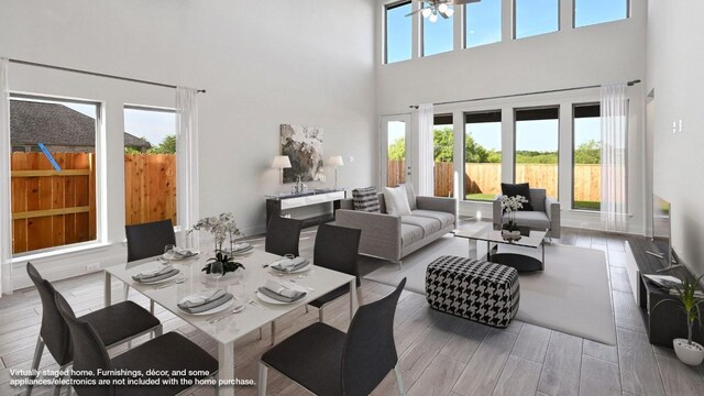 657 Bay Breeze Dr, Kyle, TX 78640 - dining area featuring a high ceiling and wood finished floors