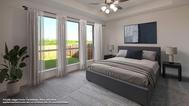 657 Bay Breeze Dr, Kyle, TX 78640 - carpeted bedroom with a raised ceiling and a ceiling fan