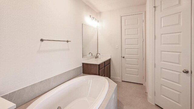 657 Bay Breeze Dr, Kyle, TX 78640 - bathroom featuring vanity, a garden tub, and tile patterned floors