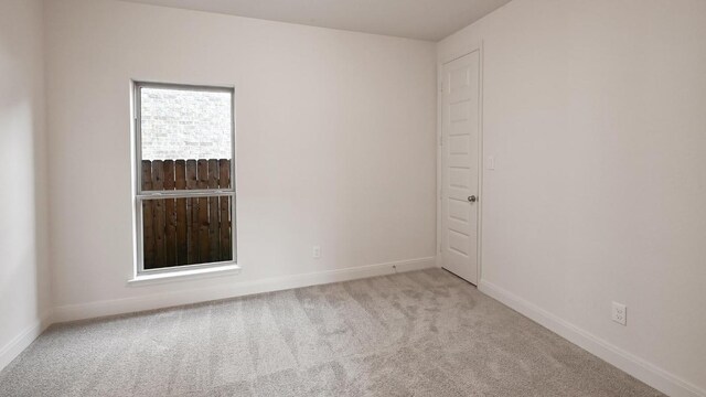 657 Bay Breeze Dr, Kyle, TX 78640 - spare room featuring carpet floors and baseboards