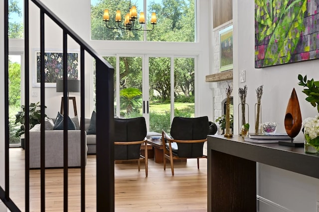 sunroom with a fireplace and a notable chandelier