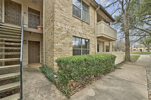 view of side of home featuring brick siding