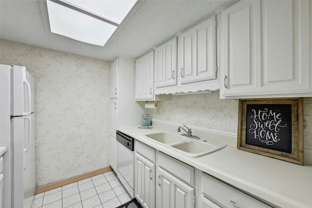 kitchen featuring light countertops, white appliances, white cabinets, and wallpapered walls