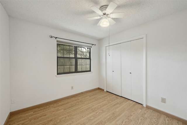 8210 Bent Tree Rd Unit 115, Austin, TX 78759 - unfurnished bedroom with light wood-style flooring, a textured ceiling, a closet, and ceiling fan