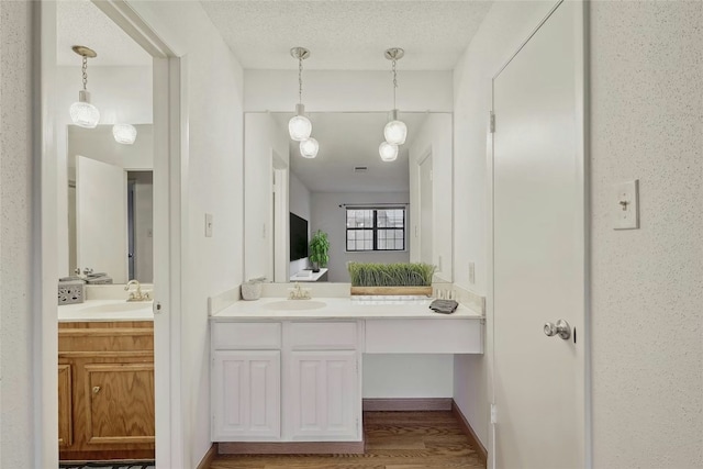 8210 Bent Tree Rd Unit 115, Austin, TX 78759 - full bathroom with vanity and wood finished floors