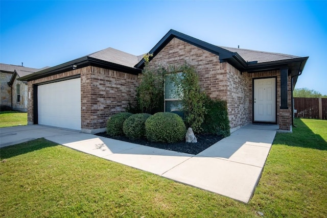 ranch-style home featuring a garage, a front lawn, concrete driveway, and brick siding