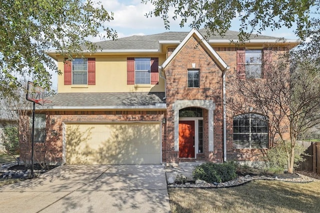 traditional-style house featuring an attached garage, roof with shingles, concrete driveway, and stucco siding