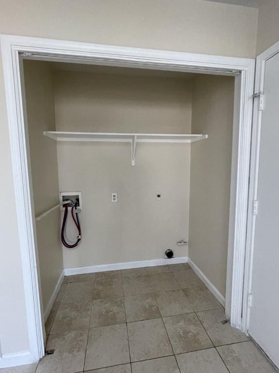 clothes washing area with baseboards, washer hookup, electric dryer hookup, and tile patterned floors