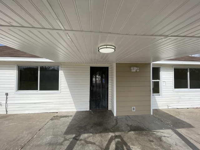 view of exterior entry featuring a patio