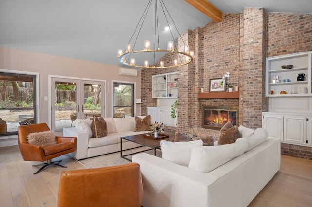 living area featuring light wood finished floors, a wall unit AC, french doors, a fireplace, and beam ceiling