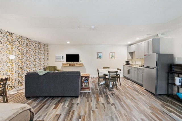 4704 Wild Briar Pass, Austin, TX 78746 - living room with light wood-style flooring, recessed lighting, wallpapered walls, and baseboards