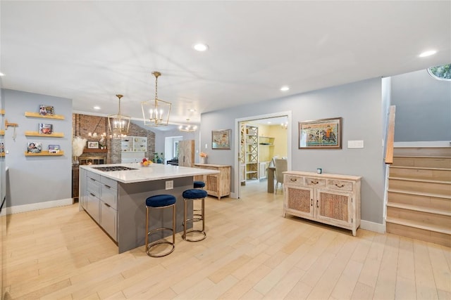 4704 Wild Briar Pass, Austin, TX 78746 - kitchen with a chandelier, recessed lighting, baseboards, light countertops, and a kitchen island