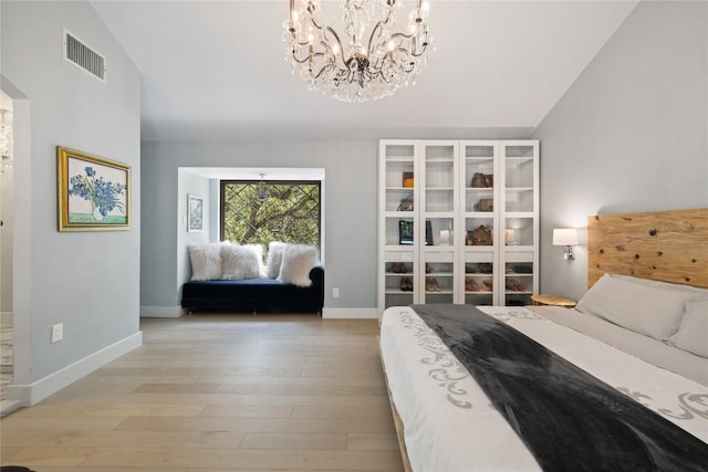 4704 Wild Briar Pass, Austin, TX 78746 - bedroom with a chandelier, light wood-style floors, baseboards, and lofted ceiling