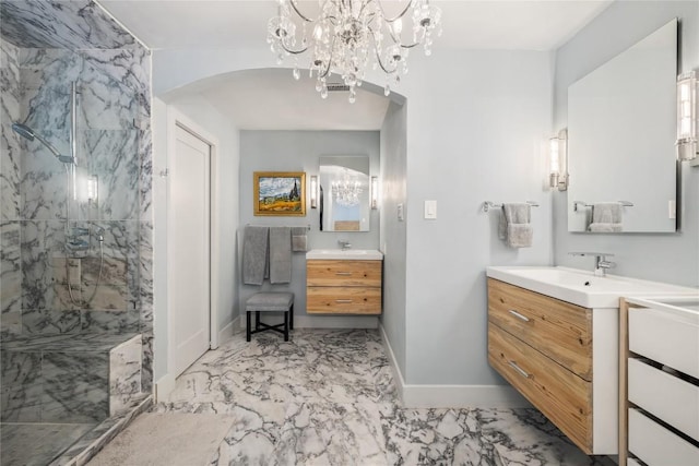 4704 Wild Briar Pass, Austin, TX 78746 - bathroom with marble finish flooring, baseboards, a marble finish shower, two vanities, and a chandelier
