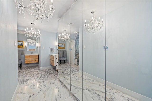 4704 Wild Briar Pass, Austin, TX 78746 - full bathroom featuring a chandelier, vanity, marble tiled floors, and baseboards