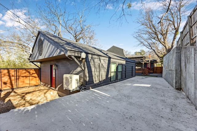 view of home's exterior featuring ac unit, a patio area, and fence