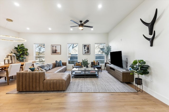 living room featuring light wood-style floors, recessed lighting, baseboards, and a ceiling fan