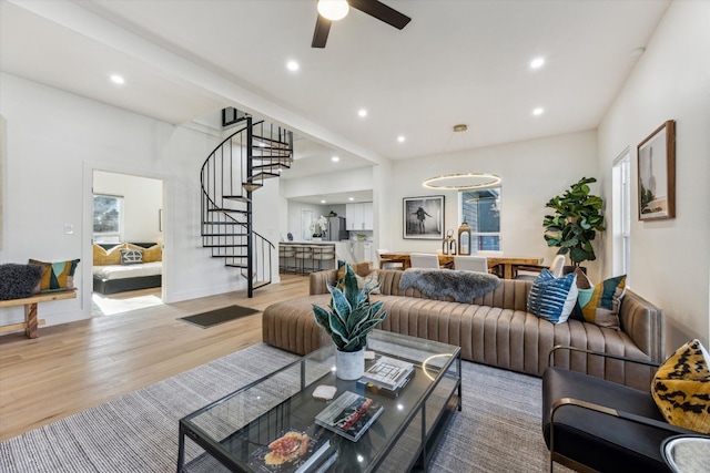 living room with recessed lighting, stairway, ceiling fan, wood finished floors, and baseboards