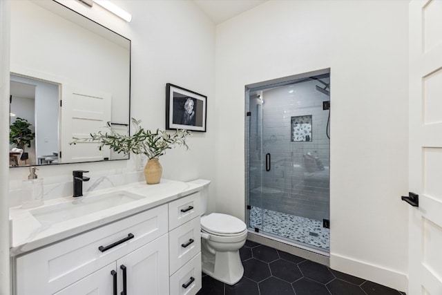 full bathroom with baseboards, toilet, tile patterned floors, vanity, and a shower stall