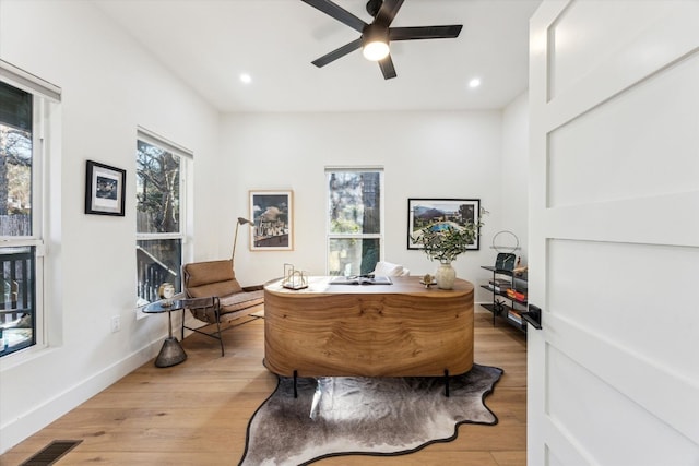 office featuring light wood-style flooring, recessed lighting, a ceiling fan, baseboards, and visible vents