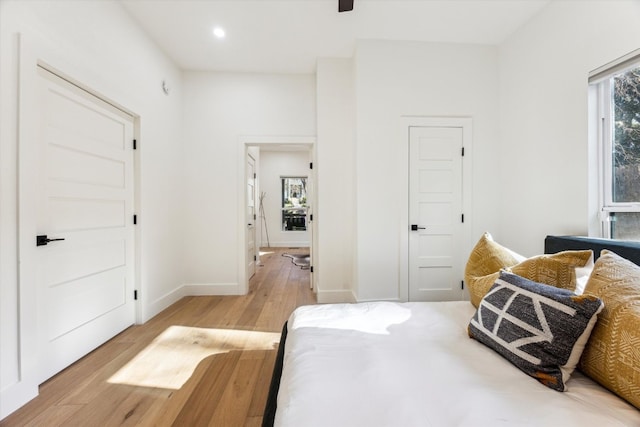 bedroom with ceiling fan, light wood finished floors, recessed lighting, and baseboards