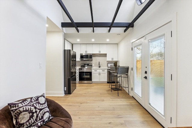 interior space featuring light wood finished floors, recessed lighting, and french doors