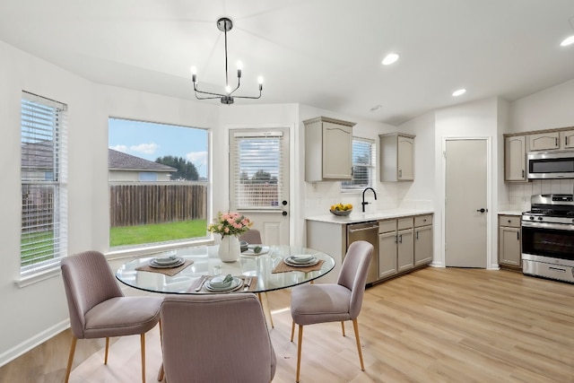 114 Challenger, Kyle, TX 78640 - dining area featuring light wood-style floors, a chandelier, recessed lighting, and baseboards