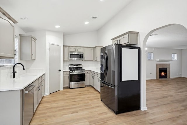 114 Challenger, Kyle, TX 78640 - kitchen featuring stainless steel appliances, a sink, gray cabinetry, light wood-style floors, and recessed lighting