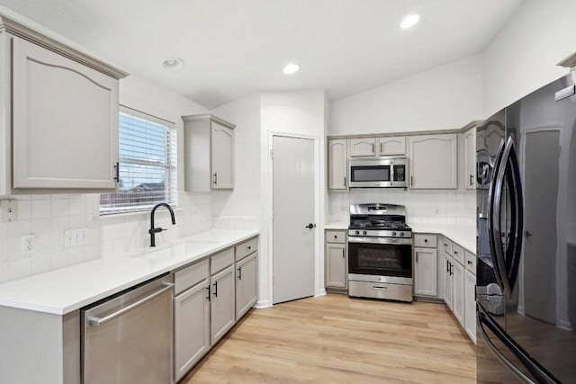 114 Challenger, Kyle, TX 78640 - kitchen with appliances with stainless steel finishes, a sink, gray cabinetry, tasteful backsplash, and recessed lighting