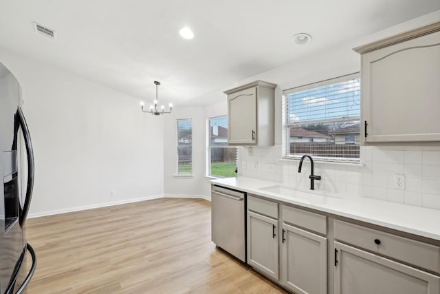 114 Challenger, Kyle, TX 78640 - kitchen with dishwasher, a sink, fridge with ice dispenser, backsplash, and recessed lighting